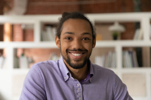 Head shot portrait African 30s man smile look at camera, profile picture of guy, webinar participant, stream video call event virtual meeting for business, fun, personal distance communication concept